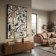 Aurista Gold Stripe Linear Abstract Cotton Spray Wall Art by Giant Sculptures displayed above a walnut sideboard in a modern living room with a blush sofa.