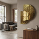 Aurargent Half-Moon Gold Textured Mirror 3D Wall Art by Giant Sculptures mounted on a grey wall above a walnut sideboard beside a grey sofa and floor lamp.