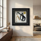 Prestivo Whip & Scroll Framed Collectible Wall Art by Giant Sculptures, displayed on a cream wall above a walnut console in a sunlit modern living room.