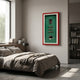 Cavendor Cigar & Badge Green Framed Wall Art by Giant Sculptures hung above a wooden bed in a modern bedroom with grey linens and a bookshelf.