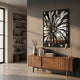 Floristra I Petal Bloom Silver Mirror 3D Wall Art by Giant Sculptures mounted above a walnut sideboard with vase, books, and brass lamp in a sunlit room.