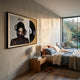 Sonarta Gold Michael Jackson Xscape Wall Art framed above a wooden bedside table and bed, with a garden view through floor-to-ceiling windows.