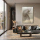 Spiralis Natural String Abstract Lines Swirl 3D Wall Art by Giant Sculptures displayed above a black leather sofa in a sunlit modern living room.