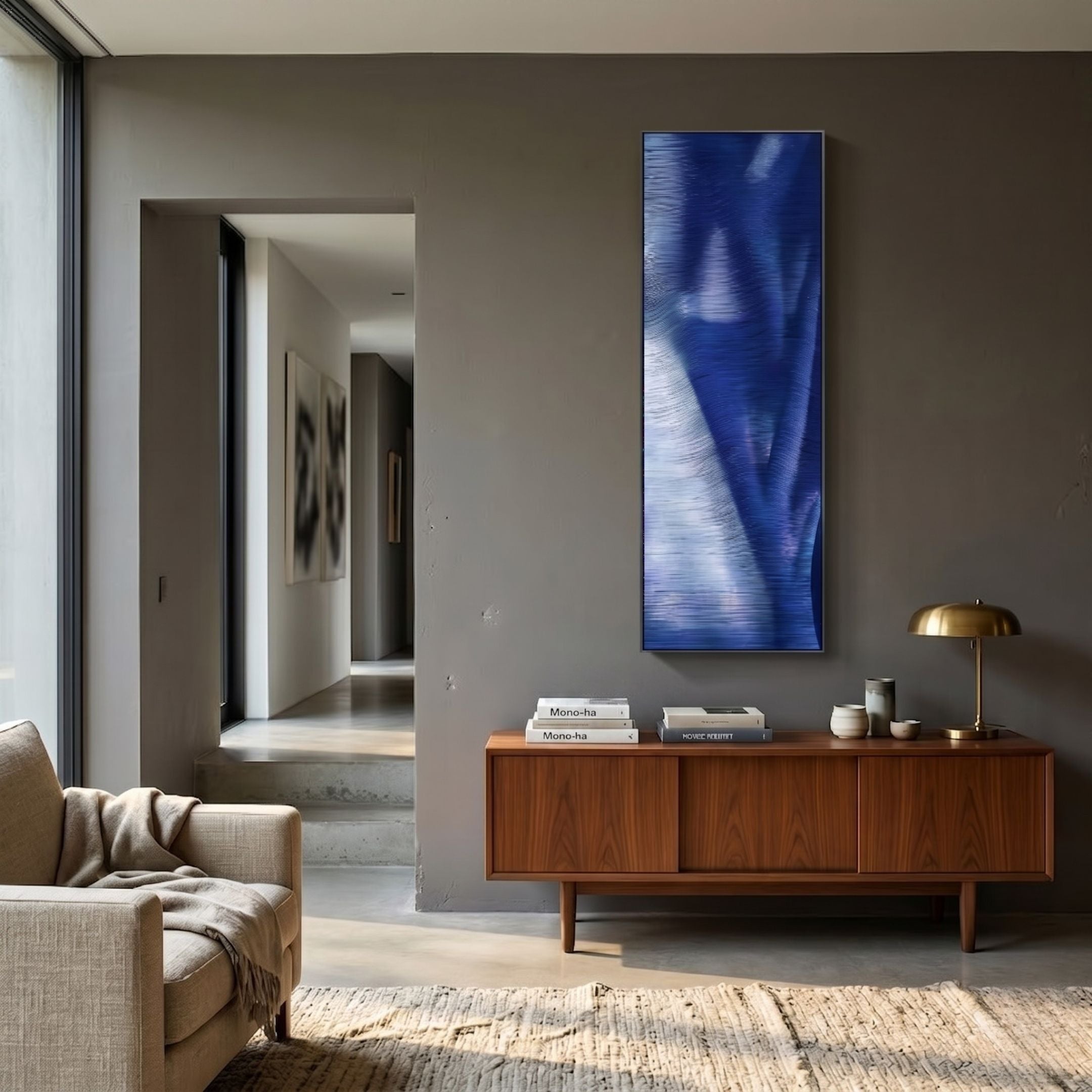 Rivara Cobalt Wave Vertical Hand-Painted Rope 3D Wall Art mounted above a walnut sideboard in a modern living room with grey walls and brass lamp.