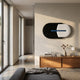 Solvia Black & White Layered Geometry 3D Wall Art by Giant Sculptures mounted above a wooden console in a sunlit modern bedroom with concrete floors.