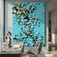 Florivine Aqua Blossom Tree Button 3D Wall Art by Giant Sculptures, with white blossoms on dark branches over turquoise, mounted above a desk in a modern office.