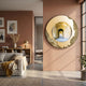 Portara Golden Archway Illusion Round 3D Wall Art by Giant Sculptures mounted on a terracotta wall above a sofa and bookshelf in a sunlit living room.