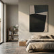 Striatura Slate Grey & Black Rope Abstract 3D Wall Art by Giant Sculptures hung above a linen bed in a minimalist bedroom with concrete floor and bookshelf.