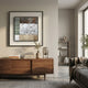 Aerolith Stone Patterned Abstract Textured Framed Wall Art in sage, brown, white, and beige bands above a walnut sideboard with books, vase, and lamp.