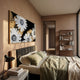 Floravida White & Gold Crystal Daisy Floral 3D Wall Art by Giant Sculptures mounted above an upholstered bed in a warm-toned bedroom with a walnut bookshelf.