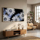 Floravida White & Blue Crystal Daisy Floral 3D Wall Art mounted above a wooden console in a modern living room with a tan sofa and bookshelf.