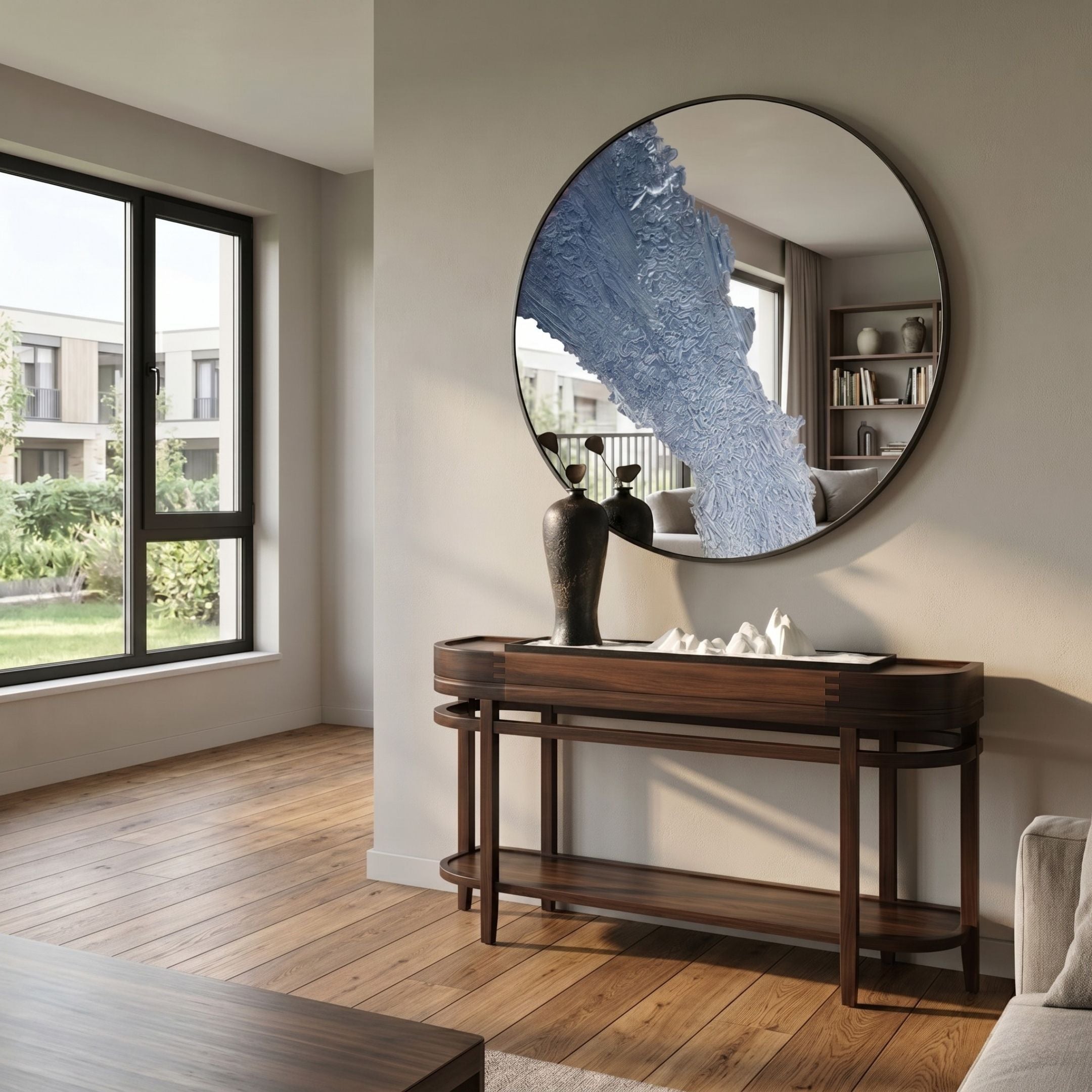 Erosian Blue Flow Textured Round Mirror 3D Wall Art by Giant Sculptures mounted above a dark wood console table in a sunlit modern living room.