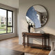 Erosian Blue Flow Textured Round Mirror 3D Wall Art by Giant Sculptures mounted above a dark wood console table in a sunlit modern living room.