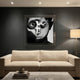 CineLuxe Vintage Camera Boy Black & White Portrait Wall Art by Giant Sculptures, acrylic print of a close-up face holding a vintage camera, mounted on a dark wall above a cream sofa in a modern living room.