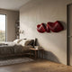 Aeravox Red Waveform Sculptural 3D Wall Art by Giant Sculptures, mounted above a bed in a modern bedroom with beige walls, grey linens, and wood flooring.