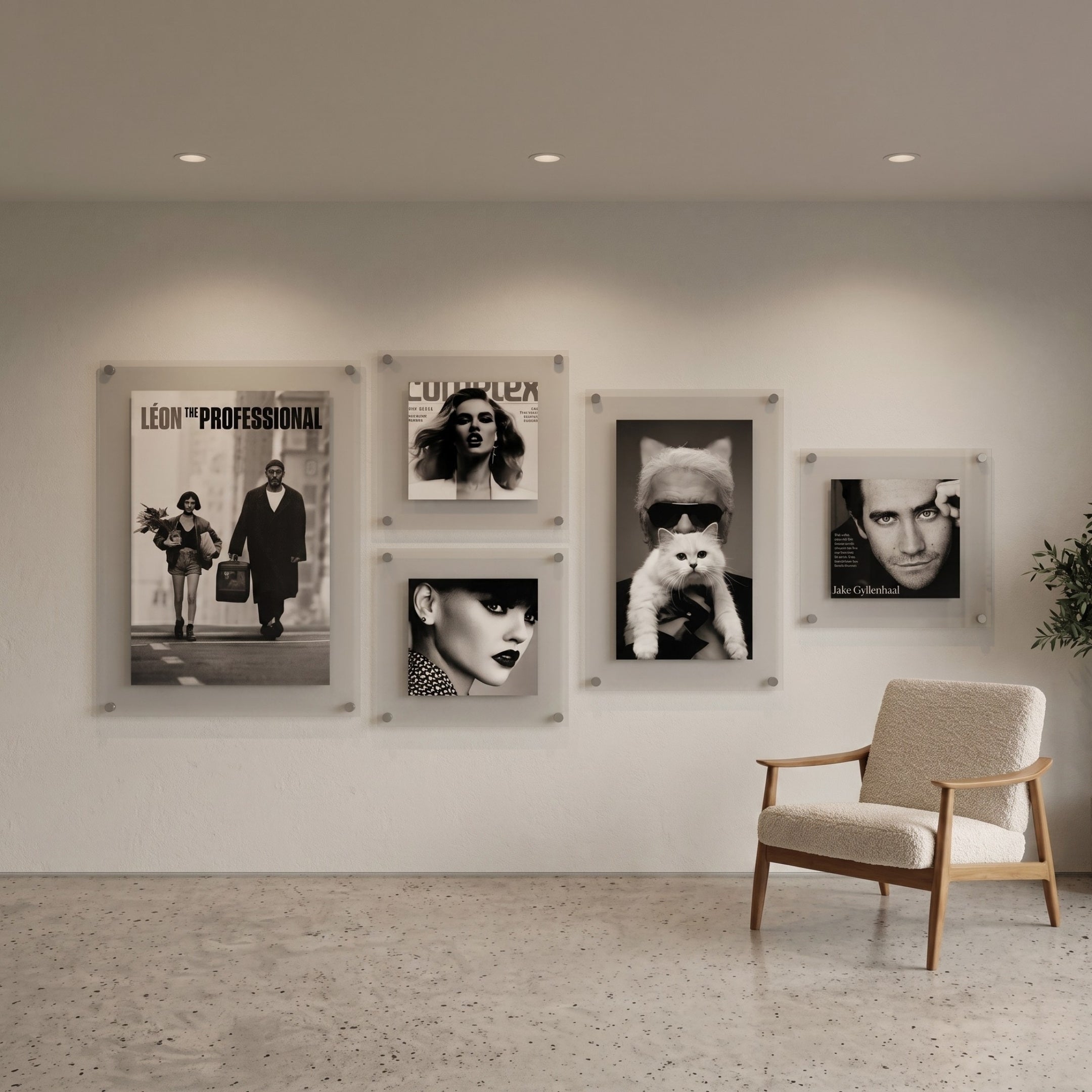 CineLuxe Fashion Icons Retro 5-Panel Acrylic Wall Art by Giant Sculptures displayed on a light wall, featuring monochrome film and fashion portraits with floating acrylic mounts, beside a mid-century chair.