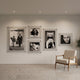 CineLuxe Fashion Icons Retro 5-Panel Acrylic Wall Art by Giant Sculptures displayed on a light wall, featuring monochrome film and fashion portraits with floating acrylic mounts, beside a mid-century chair.