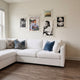 CineLuxe Classic Icons Retro 5-Panel Acrylic Wall Art by Giant Sculptures displayed above a white sectional sofa, featuring five floating acrylic panels with black-and-white portraits and a color movie poster.