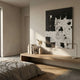 Averis Black & White Swirl Abstract 3D Wall Art by Giant Sculptures displayed above a low wooden console with books and pampas grass in a minimalist bedroom.