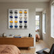 Blockform Star Wars 16-Character Pods Acrylic 3D Wall Art by Giant Sculptures mounted above a wooden sideboard in a modern bedroom with books and decor.