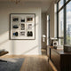 Optivis Vintage Lens & Camera Ensemble 3D Wall Art by Giant Sculptures displayed in a sunlit modern living room with wooden floor, walnut sideboard, and leather chair.