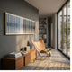 Straviu White Flow Stripe Acrylic 3D Wall Art in a gold frame mounted above a walnut sideboard, beside a tan leather butterfly chair in a sunlit room.