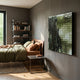 Miravax Olive Ripple Grid Acrylic 3D Wall Art mounted on a grey bedroom wall above a side table, beside a bed with olive and terracotta linen.