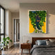 Truvira Bay Window Cottage Moss Framed 3D Wall Art by Giant Sculptures, featuring a sculpted tree with preserved moss canopy on yellow, displayed above a bedside table in a modern bedroom.