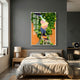 Truvira Sunset Watch Cat Moss Framed 3D Wall Art with sculpted tree, preserved green moss, and black cat silhouette overlooking an orange sunset, above a bed.