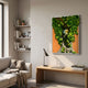 Truvira Firefly Dream Moss Framed 3D Wall Art displayed above a wooden bench in a sunlit living room with corner bookshelves and a beige sofa.