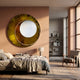 Solara Amber White Disc & Metal Ring 3D Wall Art by Giant Sculptures mounted above a bed in a warm peach bedroom with armchair and bookshelf nearby.