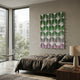 Foliora Green & Orchid Grid Leaf Acrylic 3D Wall Art mounted above a bed with brown linens, beside a floor-to-ceiling window and wire chair.