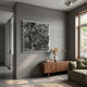 Auralith Grey Layered Leather & Acrylic 3D Wall Art mounted on a grey wall above a walnut sideboard with pampas grass, beside a green sofa and window.