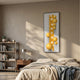 Orbevo White & Yellow Sphere Vertical 3D Acrylic Wall Art with glossy yellow spheres and orange stripe, mounted above a bed beside a timber nightstand.
