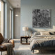Auralith Grey Layered Leather 3D Wall Art by Giant Sculptures displayed above a wooden nightstand in a modern bedroom with linen bedding and a leather armchair.