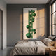 Orbevo White & Green Sphere Vertical 3D Acrylic Wall Art by Giant Sculptures mounted above a linen-dressed bed in a grey-walled bedroom with large windows.