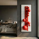 Orbevo White & Red Sphere Vertical 3D Acrylic Wall Art by Giant Sculptures mounted on a dark grey bedroom wall beside a bed and desk with task lamp.