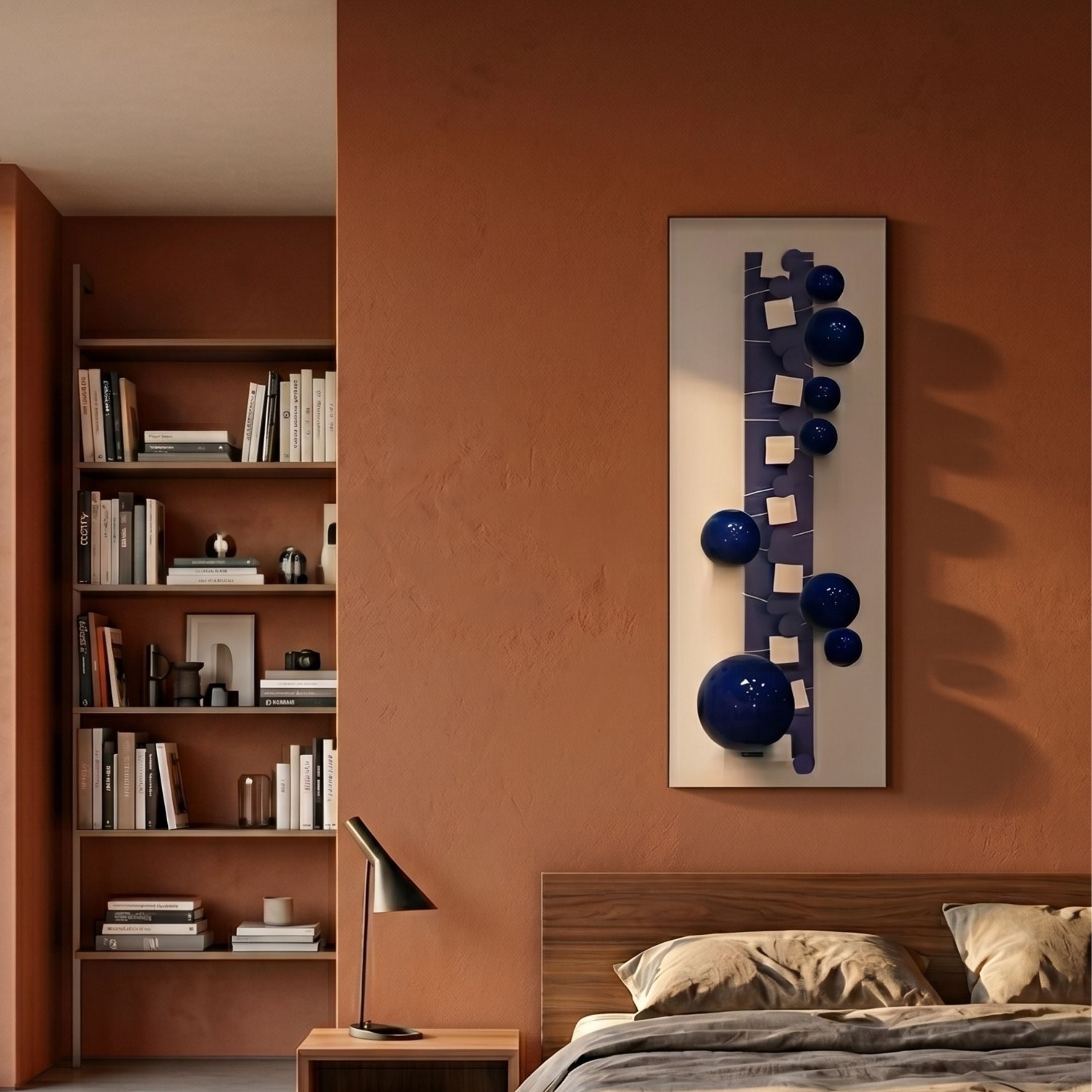 Orbevo White & Blue Sphere Vertical 3D Acrylic Wall Art by Giant Sculptures mounted on a terracotta bedroom wall beside a wooden bookshelf and bed.