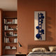 Orbevo White & Blue Sphere Vertical 3D Acrylic Wall Art by Giant Sculptures mounted on a terracotta bedroom wall beside a wooden bookshelf and bed.