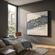 Fractura Deep Indigo Square 3D Acrylic Wall Art by Giant Sculptures mounted on a dark grey bedroom wall above a blue-linen bed, beside a window and leather chair.
