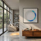 Virelium Azure Gradient Single Ring Acrylic 3D Wall Art by Giant Sculptures displayed above a wood console in a sunlit modern living room with sofa.