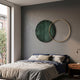 Auricara Deep Teal Disc & Metal Ring 3D Wall Art by Giant Sculptures mounted above a bed with navy and linen bedding in a modern grey bedroom.