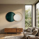 Auricara Deep Teal White Disc & Metal Ring 3D Wall Art by Giant Sculptures displayed above a wooden sideboard in a sunlit living room beside a linen sofa.