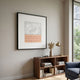 Terracube VII Hand-Painted Framed Acrylic 3D Wall Art by Giant Sculptures with grey brushstrokes and peach cube grid, displayed above a walnut bookshelf in a living room.