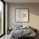 Terracube VI Hand-Painted Framed Acrylic 3D Wall Art by Giant Sculptures, with grey painted ground and peach cube grid, hung above a blue-linen bed.