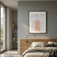 Terracube III Hand-Painted Framed Acrylic 3D Wall Art by Giant Sculptures, with peach cube grid on textured grey, hung above a wooden bed in a modern bedroom.