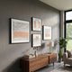 Terracube 4-Set Hand-Painted Framed Acrylic 3D Wall Art by Giant Sculptures arranged on a grey wall above a walnut sideboard with lamp and plants.