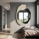 Ravira Ivory & Black Sculptural Acrylic Mirror 3D Wall Art by Giant Sculptures displayed on a grey bedroom wall above a bed with mauve linens.