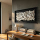 Stravira Black II Sculptural White Metal 3D Wall Art by Giant Sculptures displayed above a wooden desk with books and a lamp in a modern office.