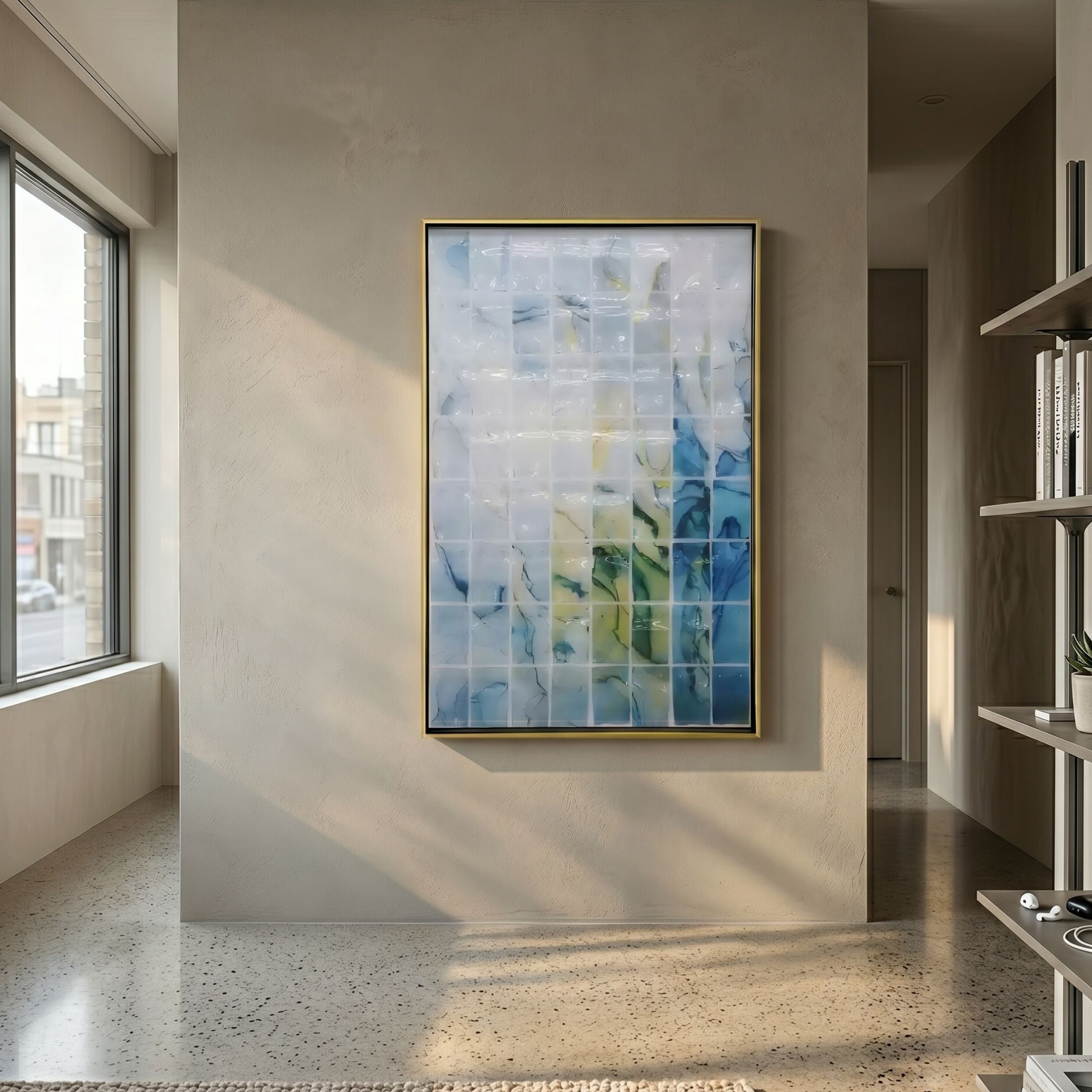 Clarique Blue & Citrus Vein Grid Acrylic 3D Wall Art by Giant Sculptures in a brushed gold frame, mounted on a beige hallway wall beside a sunlit window.